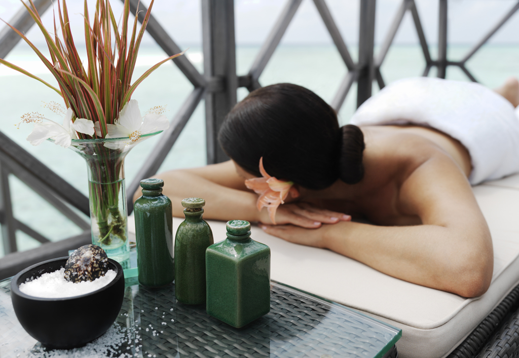 beautiful woman getting spa treatment at daylight near the ocean